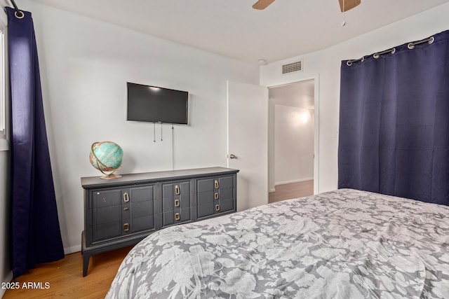 bedroom with ceiling fan and light hardwood / wood-style flooring