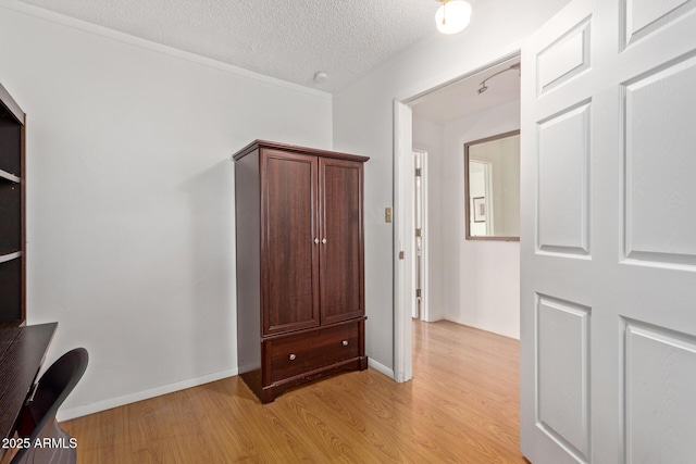 interior space with light hardwood / wood-style floors and a textured ceiling