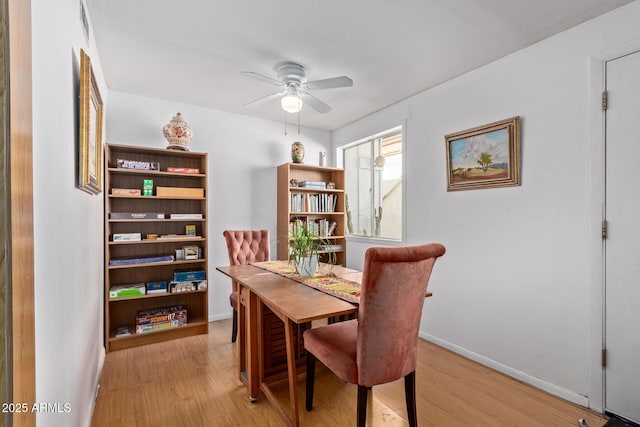 dining space featuring ceiling fan and light hardwood / wood-style flooring