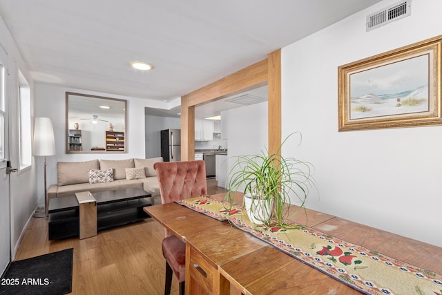 dining space with light hardwood / wood-style floors