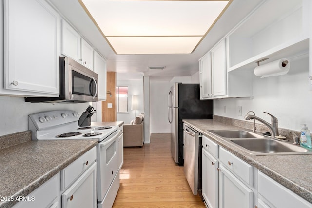 kitchen featuring sink, light wood-type flooring, white cabinets, and appliances with stainless steel finishes