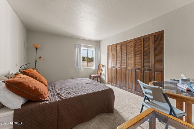 bedroom featuring a closet, a textured ceiling, and carpet flooring