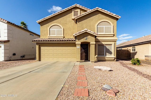 mediterranean / spanish-style home with an attached garage, fence, a tile roof, driveway, and stucco siding