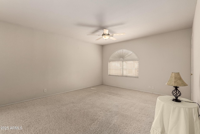 spare room with carpet floors and a ceiling fan