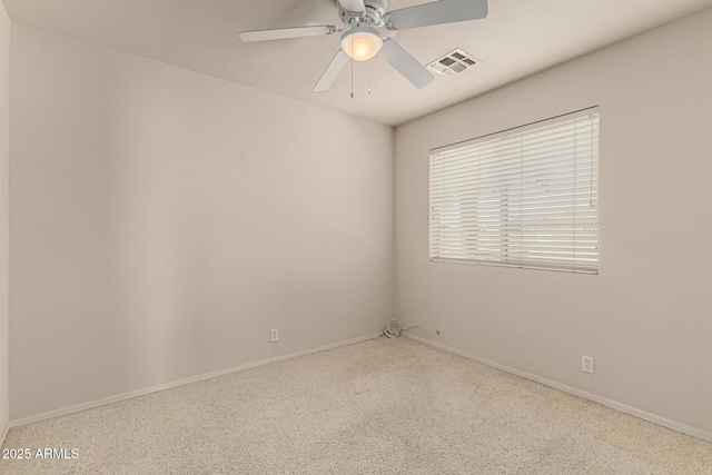 unfurnished room featuring visible vents and a ceiling fan