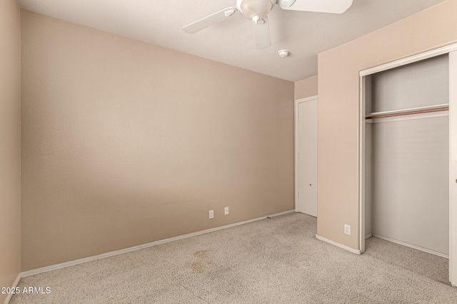 unfurnished bedroom with a closet, carpet, a ceiling fan, and baseboards