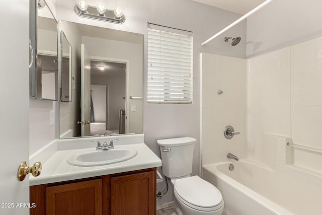 bathroom with toilet, bathing tub / shower combination, and vanity