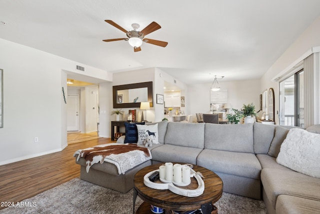 living room featuring ceiling fan and wood-type flooring