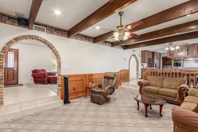 living room with ceiling fan and beam ceiling