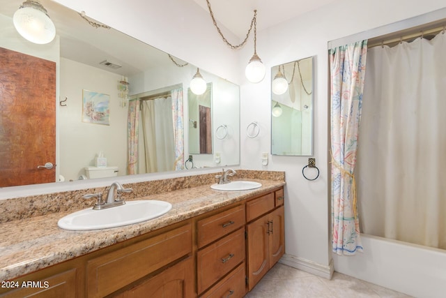 full bathroom featuring tile patterned flooring, vanity, toilet, and shower / bath combo with shower curtain