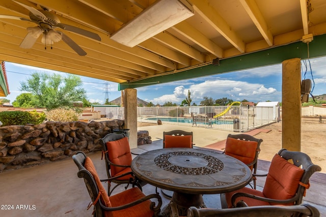 view of patio featuring ceiling fan and a fenced in pool