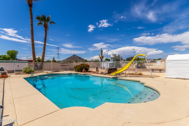 view of swimming pool featuring a patio and a water slide