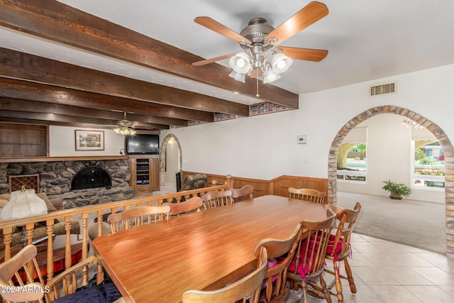 dining room with beamed ceiling, ceiling fan, and light tile patterned floors