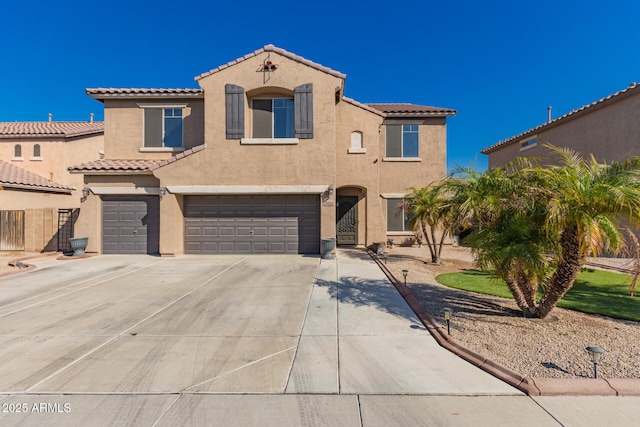 mediterranean / spanish house with stucco siding, concrete driveway, an attached garage, and a tile roof