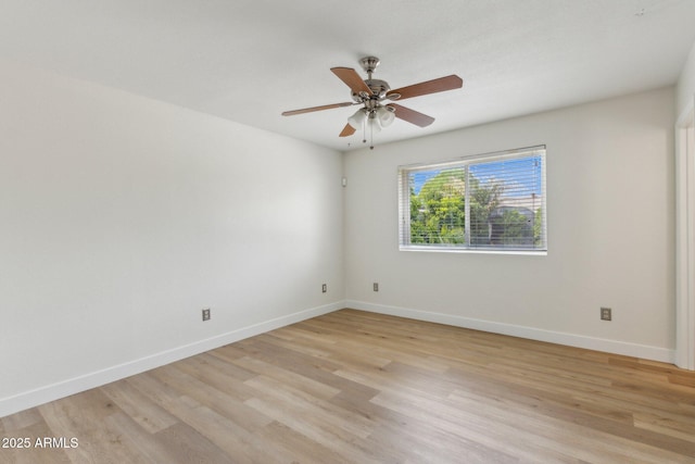 unfurnished room featuring a ceiling fan, baseboards, and light wood-style floors