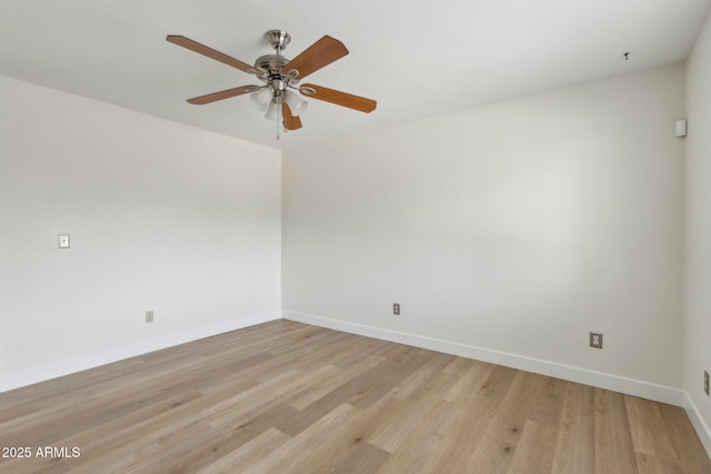 spare room featuring baseboards, ceiling fan, and light wood-type flooring