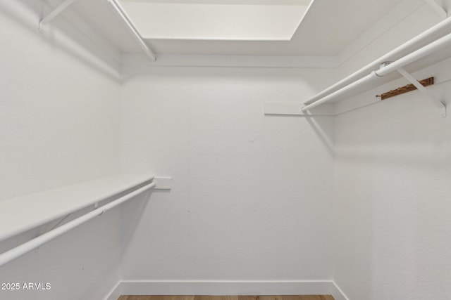 spacious closet with wood finished floors