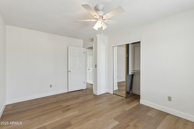 unfurnished bedroom featuring baseboards, a closet, light wood finished floors, and visible vents