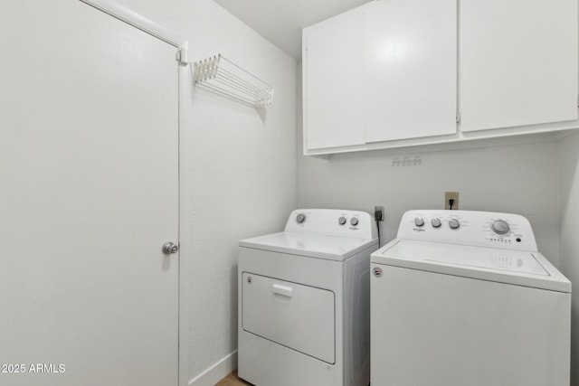laundry room featuring cabinet space and washer and dryer