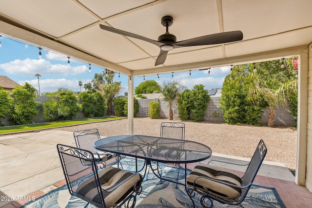 view of patio / terrace with outdoor dining area, a fenced backyard, and ceiling fan