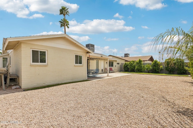rear view of house with a patio and fence