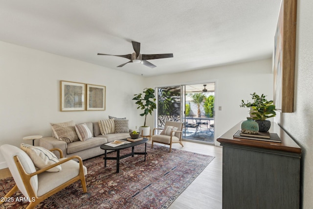 living area with ceiling fan and wood finished floors