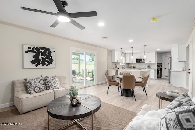 3050 E Cholla St E, Phoenix, AZ 85028 - living room with crown molding, recessed lighting, light wood-style floors, a ceiling fan, and washer / dryer