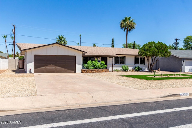 3050 E Cholla St E, Phoenix, AZ 85028 - ranch-style home with a garage, driveway, a shingled roof, and a gate