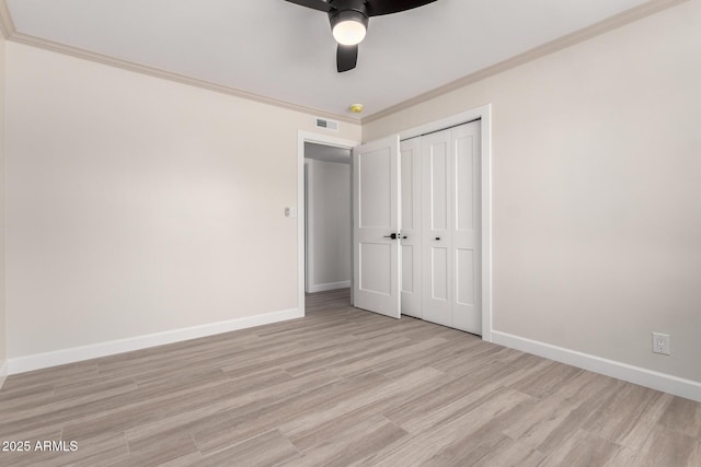 3050 E Cholla St E, Phoenix, AZ 85028 - unfurnished bedroom with light wood-style floors, a closet, ornamental molding, and a ceiling fan