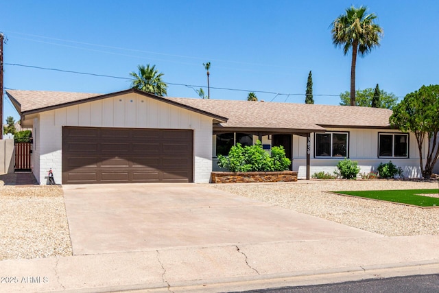3050 E Cholla St E, Phoenix, AZ 85028 - ranch-style house with an attached garage, driveway, a shingled roof, and brick siding