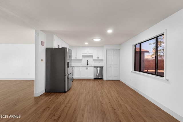 14215 N 36th Way, Phoenix, AZ 85032 - kitchen featuring stainless steel appliances, a sink, light wood finished floors, baseboards, and white cabinets