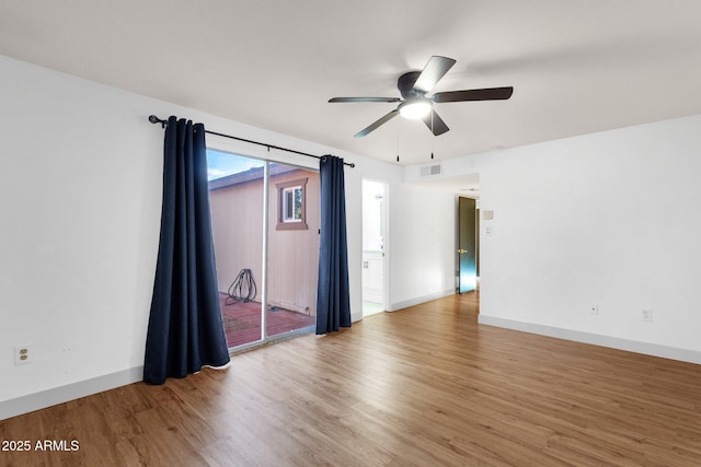 14215 N 36th Way, Phoenix, AZ 85032 - empty room with wood finished floors, a ceiling fan, and baseboards
