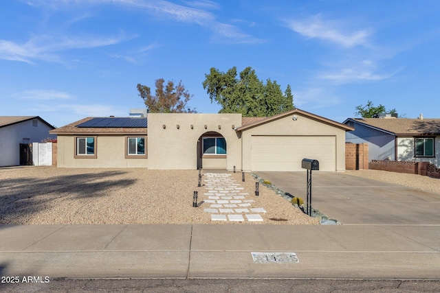 14215 N 36th Way, Phoenix, AZ 85032 - view of front of property featuring concrete driveway, stucco siding, a garage, and roof mounted solar panels