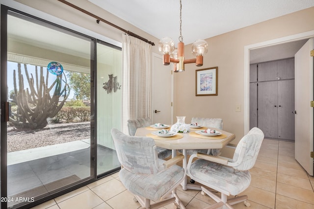 tiled dining room with a chandelier