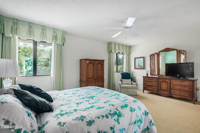 carpeted bedroom with a textured ceiling and ceiling fan