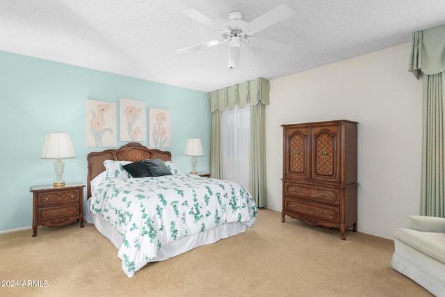 carpeted bedroom with ceiling fan and a textured ceiling