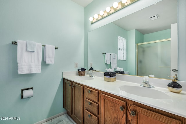 bathroom with tile patterned flooring, vanity, and a shower with shower door