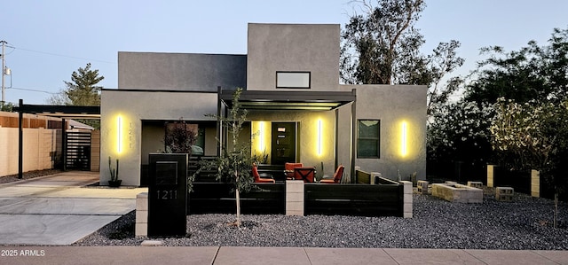 modern home featuring a fenced front yard and stucco siding