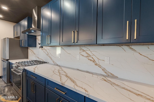 kitchen with appliances with stainless steel finishes, blue cabinetry, wall chimney exhaust hood, decorative backsplash, and light stone countertops
