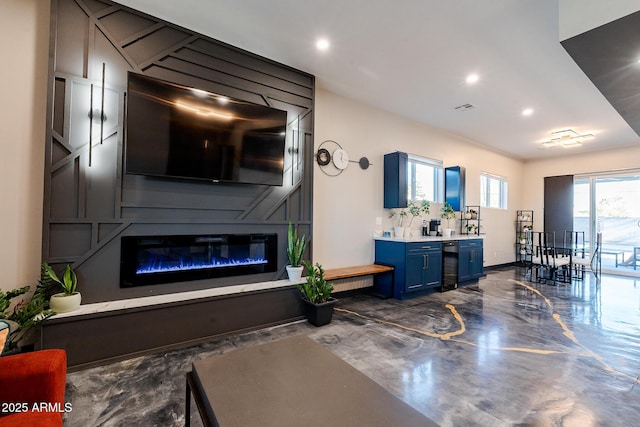 living room featuring recessed lighting, a fireplace, and baseboards
