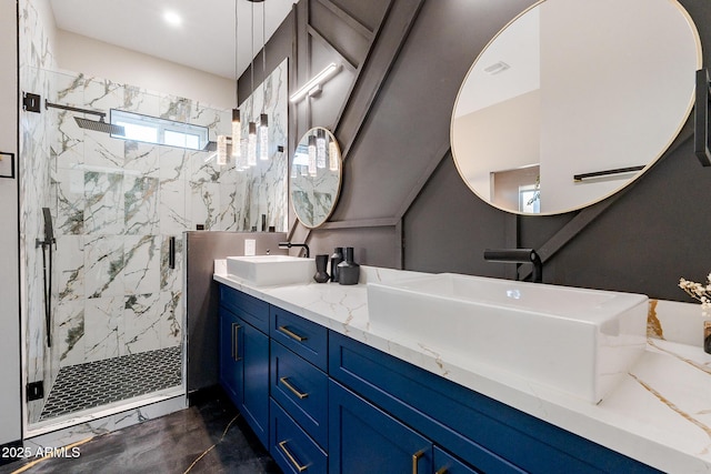 bathroom featuring a marble finish shower and double vanity