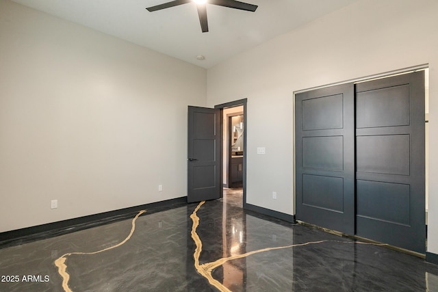 unfurnished bedroom with a ceiling fan, baseboards, and marble tiled flooring
