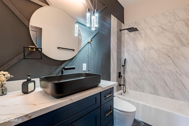 bathroom with shower / bathtub combination, toilet, and vanity