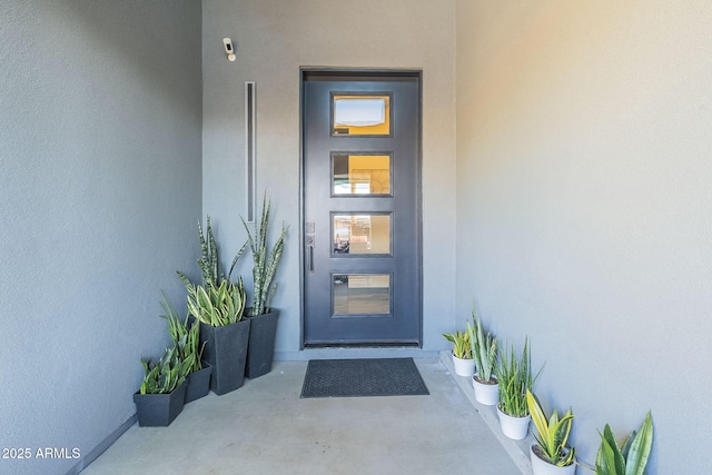 entrance to property with stucco siding