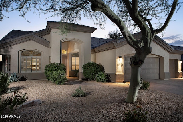14424 N 64th Pl, Scottsdale, AZ 85254 - mediterranean / spanish home with an attached garage, stucco siding, and concrete driveway