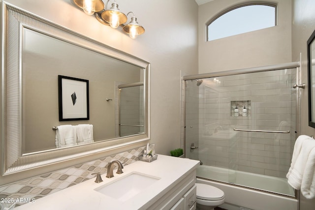 14424 N 64th Pl, Scottsdale, AZ 85254 - full bathroom with toilet, shower / bath combination with glass door, decorative backsplash, and vanity