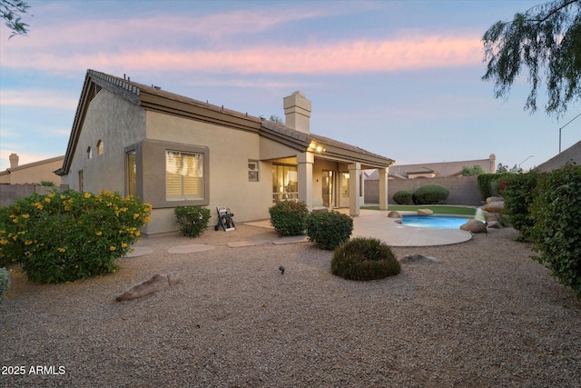 14424 N 64th Pl, Scottsdale, AZ 85254 - back of property with a chimney, a patio, a fenced backyard, and stucco siding