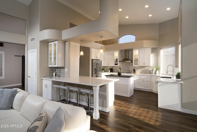14424 N 64th Pl, Scottsdale, AZ 85254 - kitchen featuring high end fridge, a sink, a high ceiling, wall chimney range hood, and open floor plan