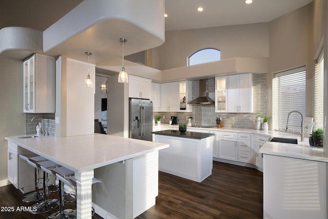14424 N 64th Pl, Scottsdale, AZ 85254 - kitchen featuring high quality fridge, wall chimney range hood, a sink, a peninsula, and a high ceiling