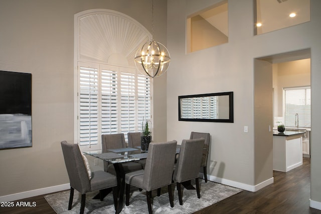 14424 N 64th Pl, Scottsdale, AZ 85254 - dining space with dark wood-style floors, a chandelier, and baseboards